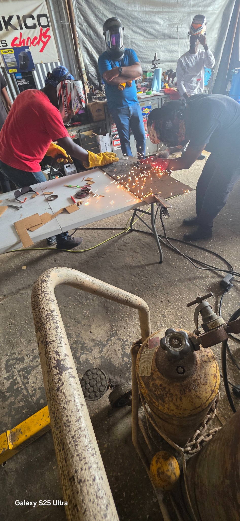 Students grinding and shaping metal