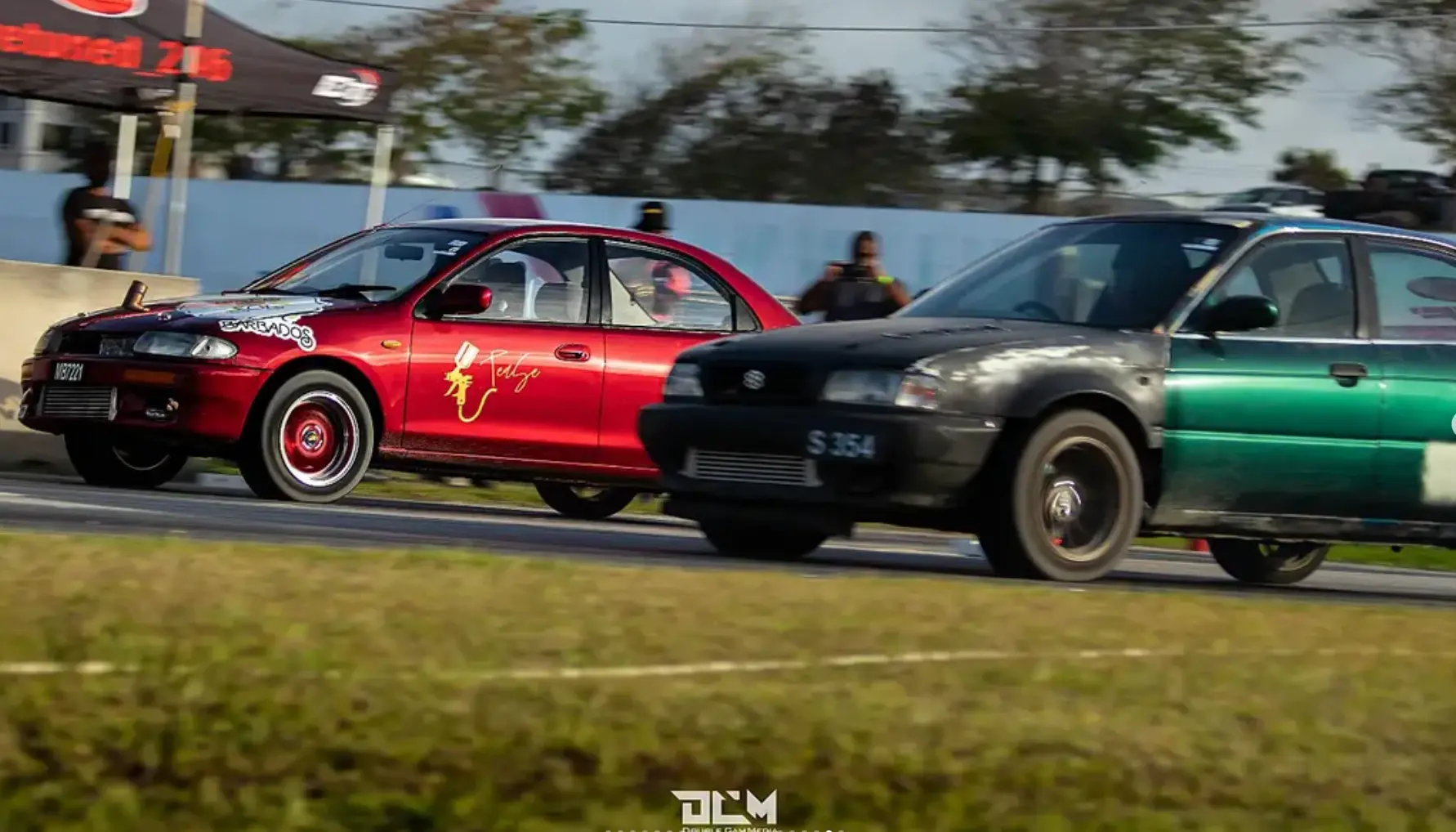 Two cars competing in Barbados drag racing