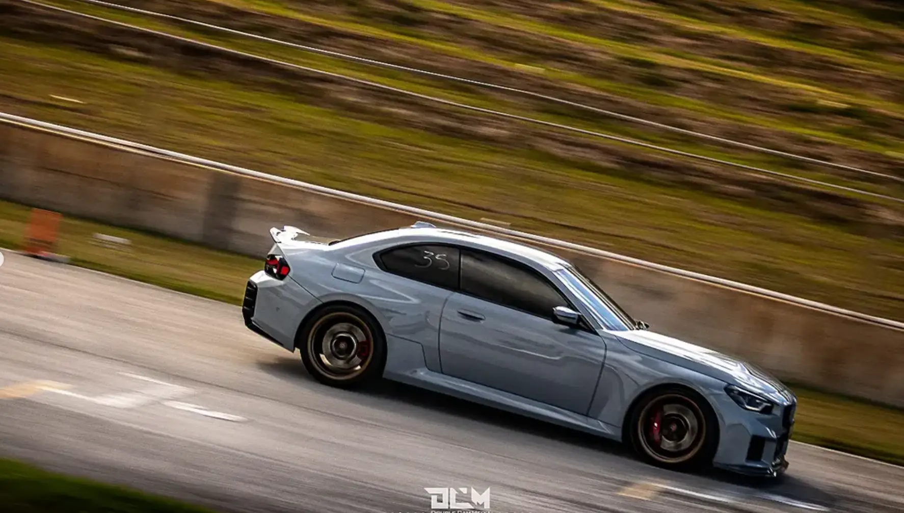 Grey performance car on circuit