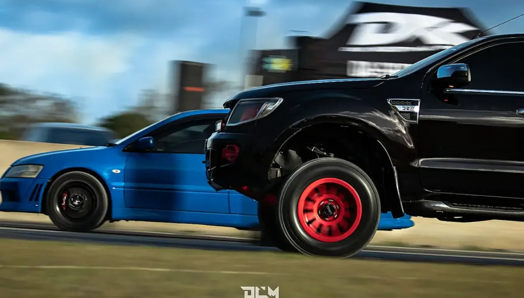 Truck and car competing side by side